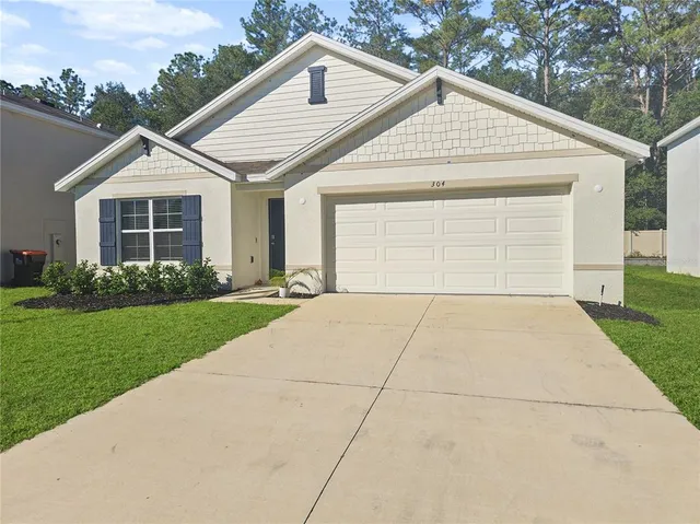 a view of a yard in front view of a house