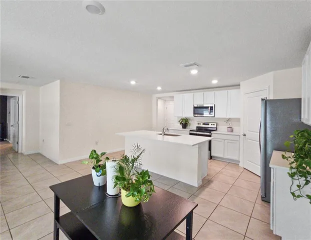 a kitchen with a table and chairs