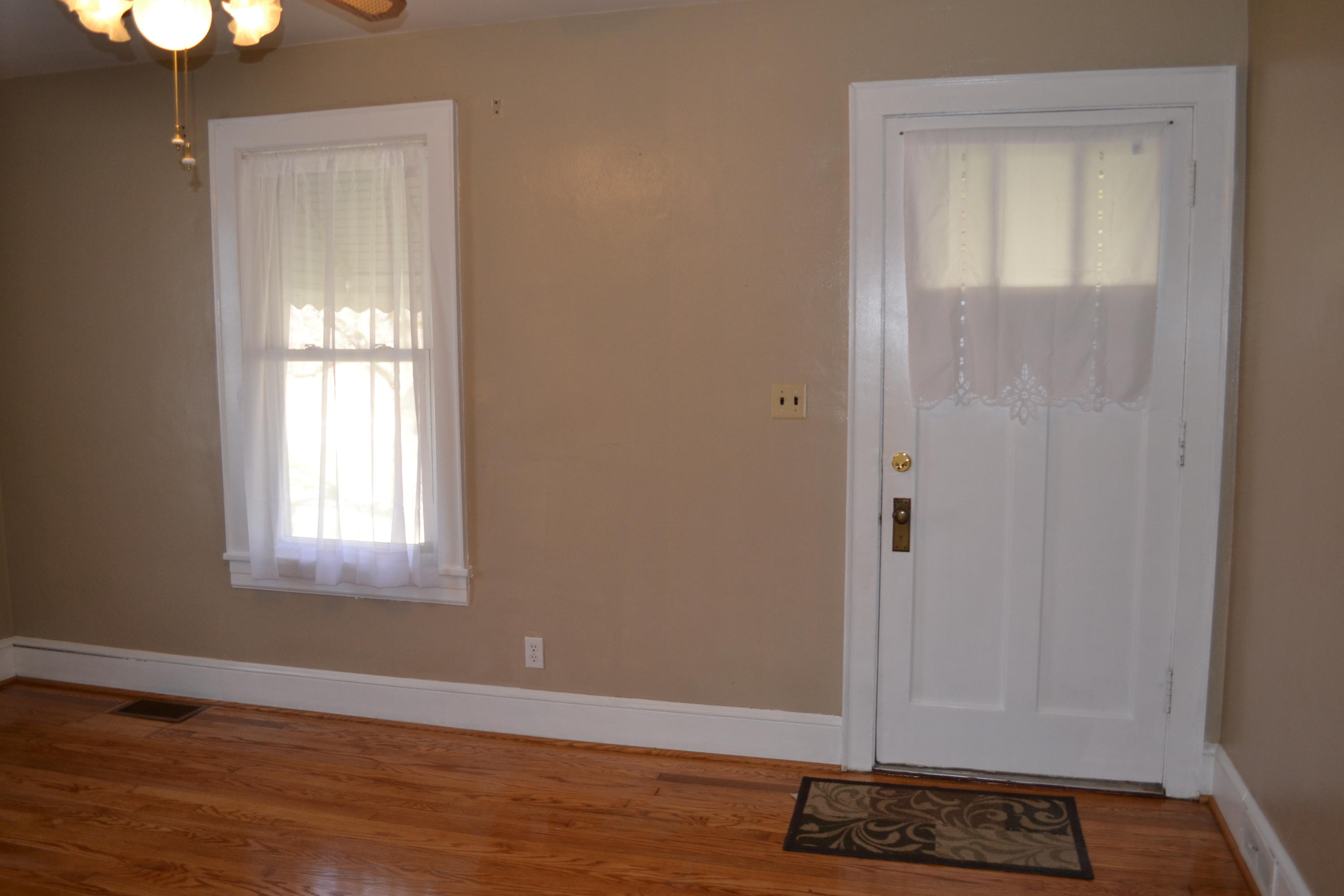 31 Mountain Pass Road Blue Ridge, VA 24064 - Photo 3 of 40 an empty room with wooden floor and windows