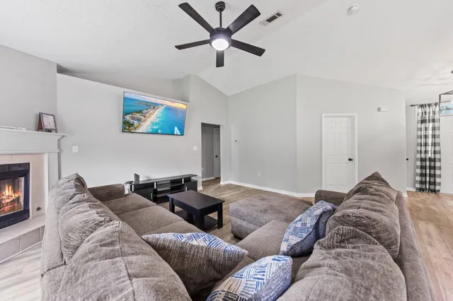 a living room with furniture and a fireplace