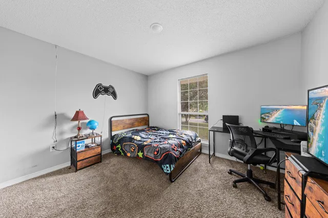 a bedroom with a bed and a desk