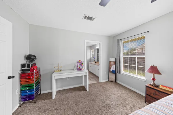 a bedroom with furniture and a window