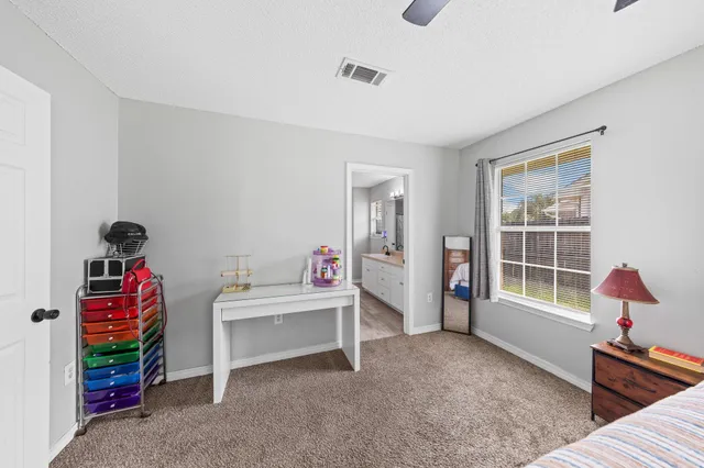 a bedroom with furniture and a window
