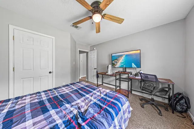 a bedroom with a bed a desk and chair