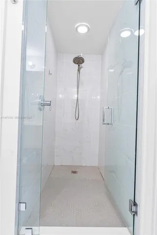 a bathroom with a glass shower door