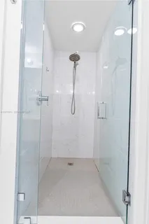 a bathroom with a glass shower door