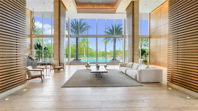 a living room with furniture and large windows