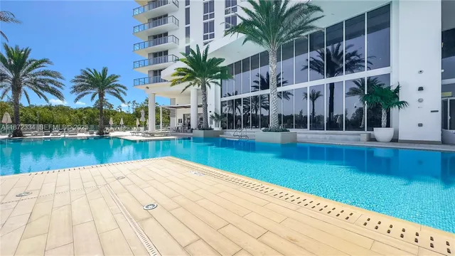 a view of a house with swimming pool and sitting area