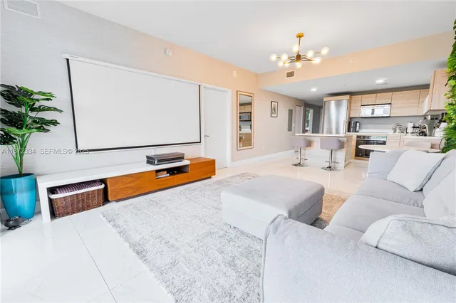 a living room with furniture and a chandelier
