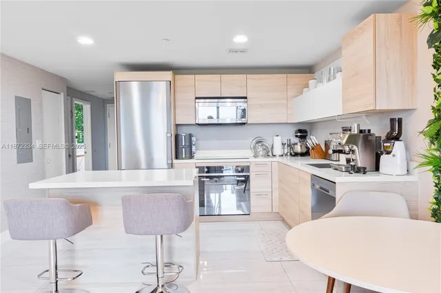 a kitchen with a stove cabinets and chairs
