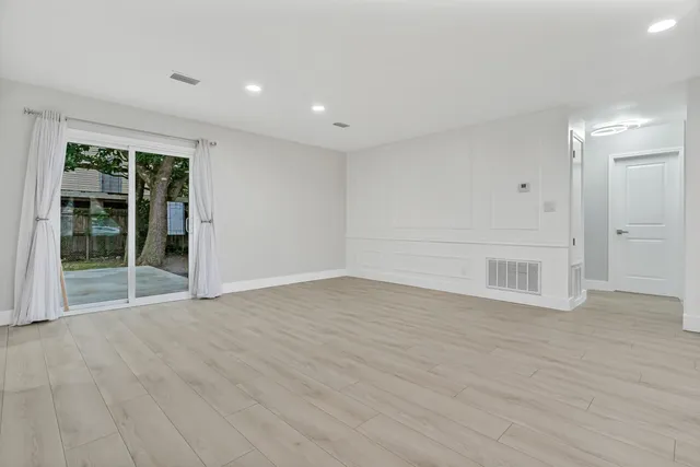 a kitchen with granite countertop a sink stove and refrigerator