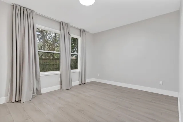 a bathroom with a sink toilet vanity and shower