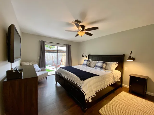 a bedroom with a bed and a flat screen tv