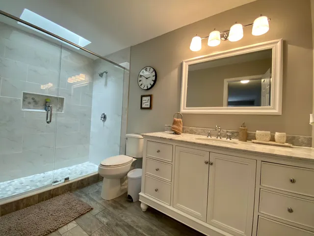 a bathroom with a toilet sink and mirror