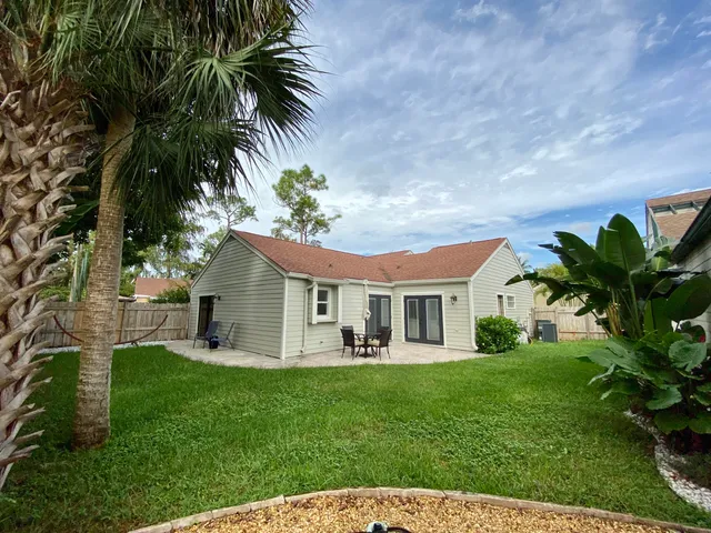a front view of house with yard and outdoor seating