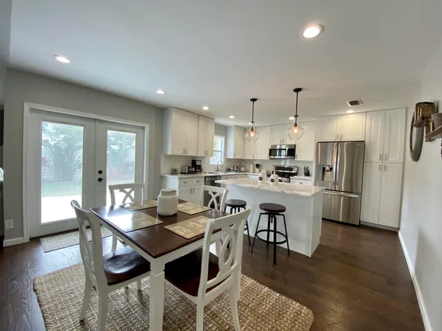 a kitchen with stainless steel appliances kitchen island granite countertop a sink and cabinets