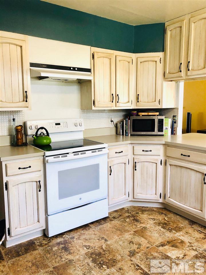 765 Mcdonald Reno, NV 89503 - Photo 6 of 15 a kitchen with stainless steel appliances white cabinets and a sink