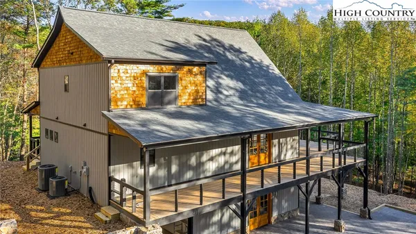 a view of a house with backyard porch and sitting area