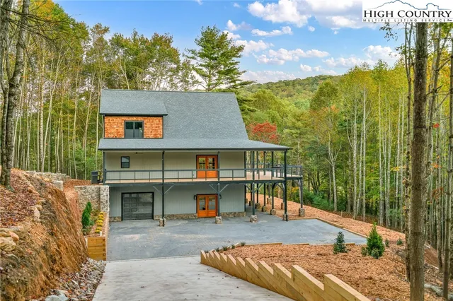 a view of a house with backyard porch and sitting area