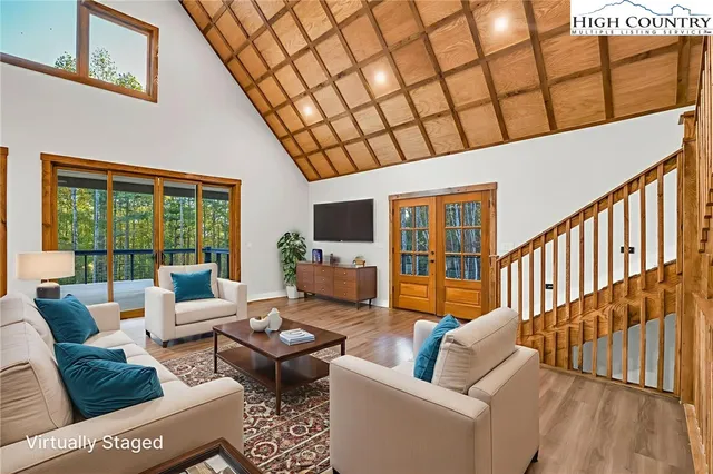 a living room with furniture ceiling fan and a rug