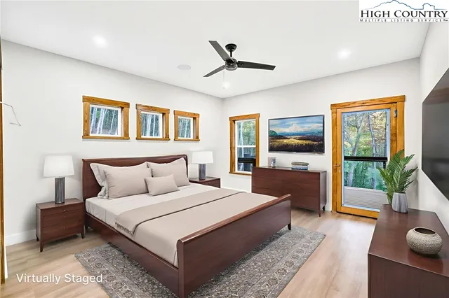 a bedroom with a large bed and a flat screen tv