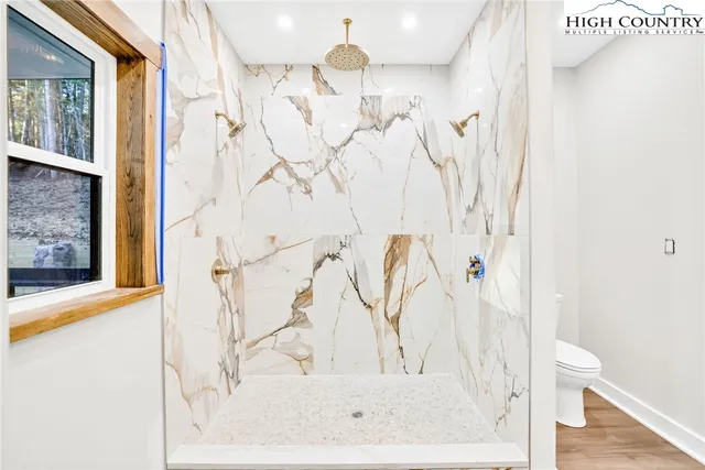 a bathroom with a bathtub and shower