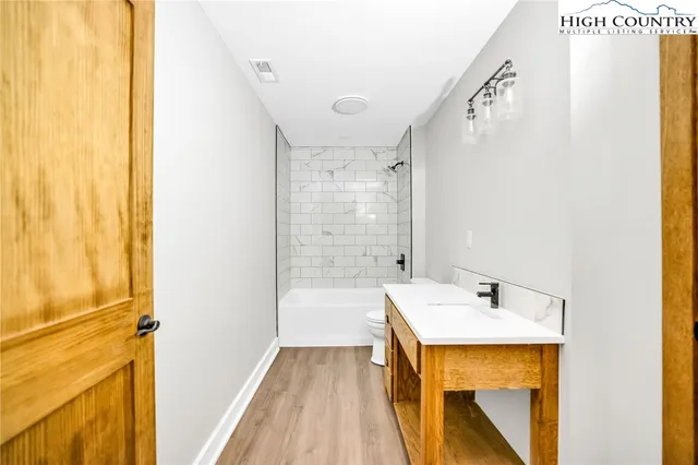 a bathroom with a sink a mirror and a bathtub
