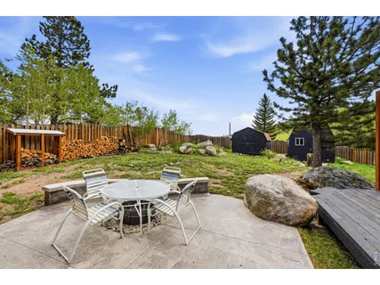 a view of a backyard with sitting area