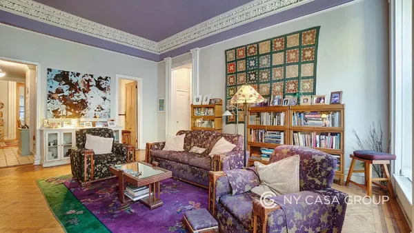 a living room with furniture and large windows