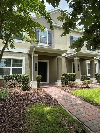 a front view of a house with yard and porch