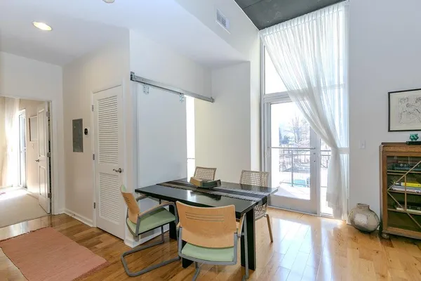 a view of a dining room with furniture and a wooden floor