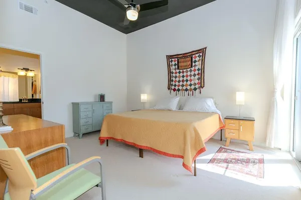 a bedroom with a bed and a couch