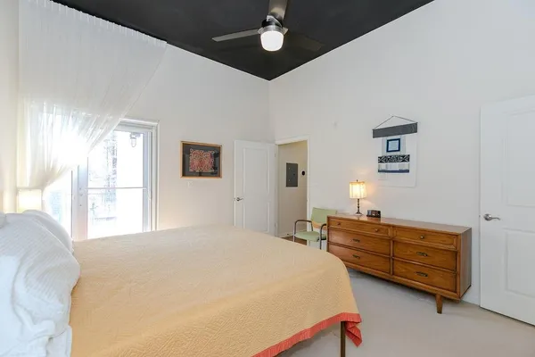 a bedroom with a bed dresser and a window