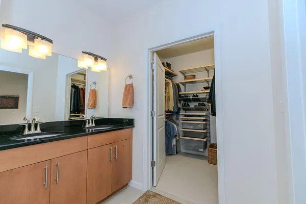 a bathroom with a double vanity sink and a mirror