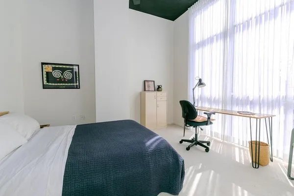 a bedroom with a bed and a chair