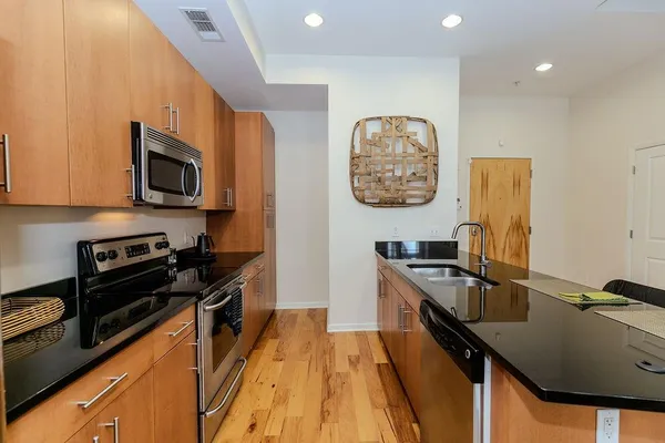 a kitchen with a refrigerator stove and microwave