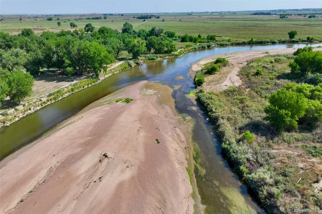 an aerial view of a house with a yard basket ball court and outdoor seating