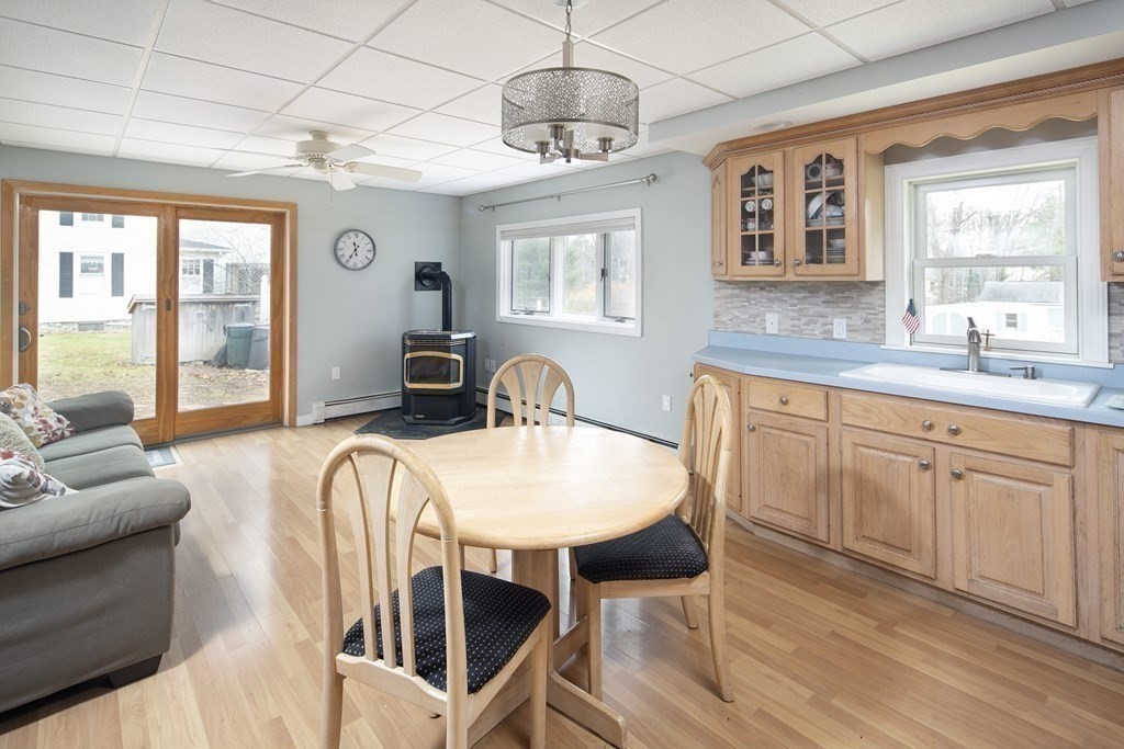 39 Shufelt Road Walpole, MA 02071 - Photo 17 of 33 a living room with furniture a dining table and chairs with wooden floor