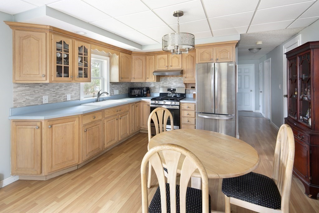 39 Shufelt Road Walpole, MA 02071 - Photo 18 of 33 a kitchen with stainless steel appliances granite countertop a kitchen island a stove a table and chairs