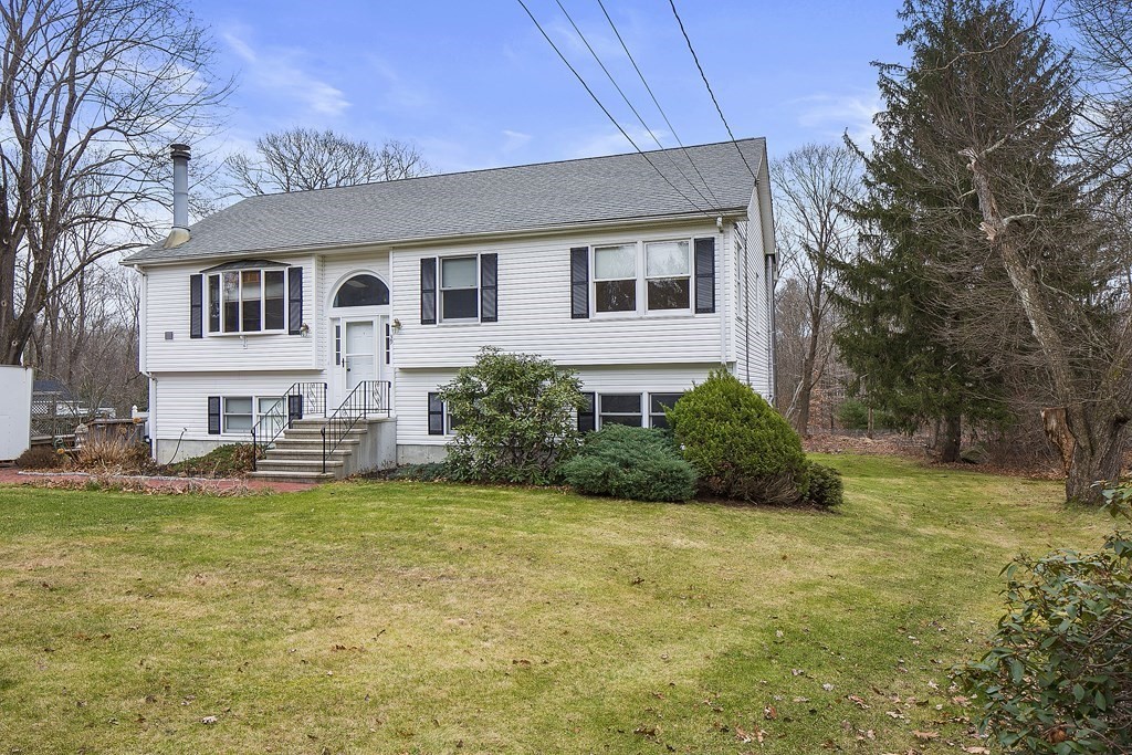 39 Shufelt Road Walpole, MA 02071 - Photo 28 of 33 a house that has a big yard with plants and trees in front of it