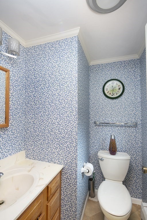39 Shufelt Road Walpole, MA 02071 - Photo 10 of 33 a bathroom with a toilet a sink and a mirror