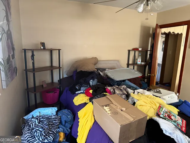 a bedroom with a bed closet and a mirror