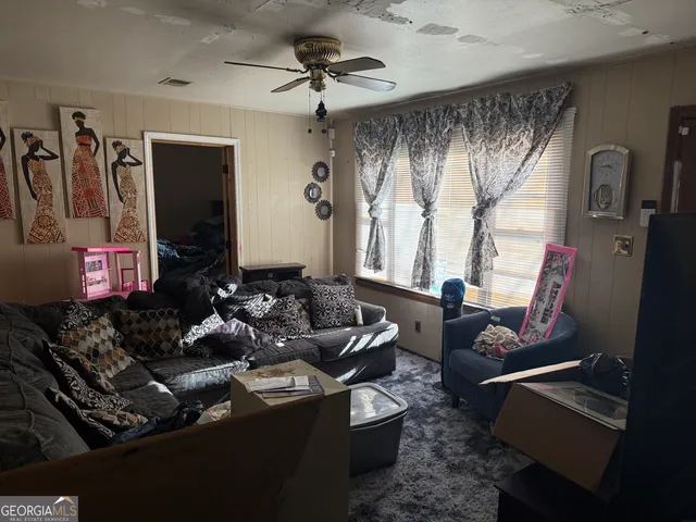 a living room with furniture and a large window