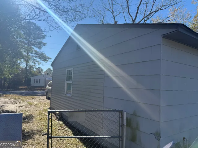 a view of a house with a wooden fence