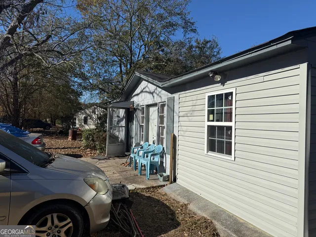 a view of a porch with furniture and floor to ceiling window