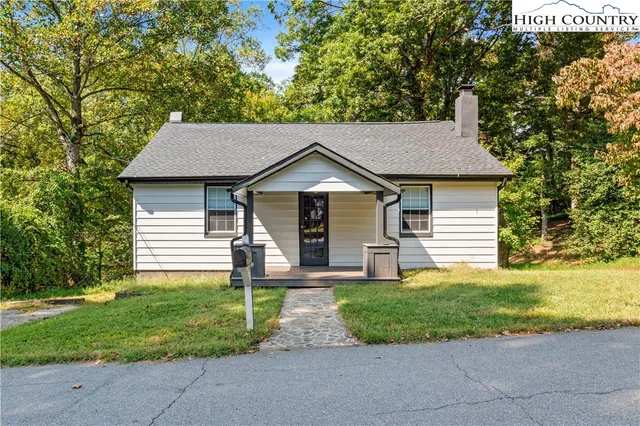 a front view of a house with yard and green space