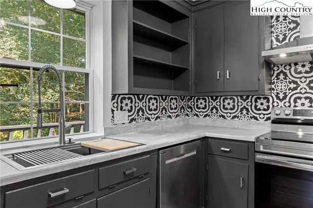 a kitchen with a sink and a stove