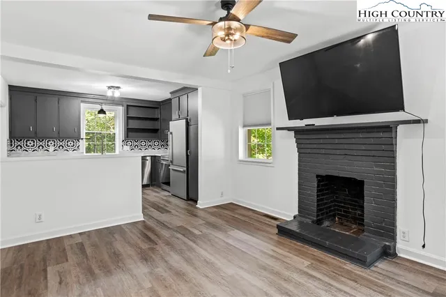 a living room with furniture a flat screen tv and a fireplace
