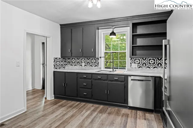 a kitchen with a sink window and cabinets