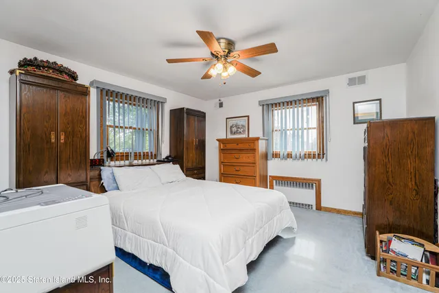 a bedroom with a large bed and a dresser